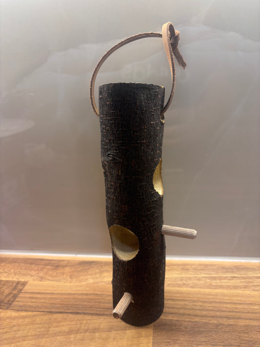 Handmade suet log bird feeder for feeding garden birds in wildlife gardens